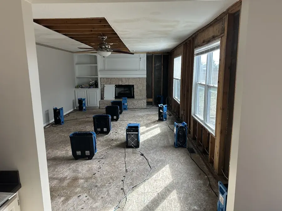 Air movers drying a room down to the studs in a Bronx, NY building