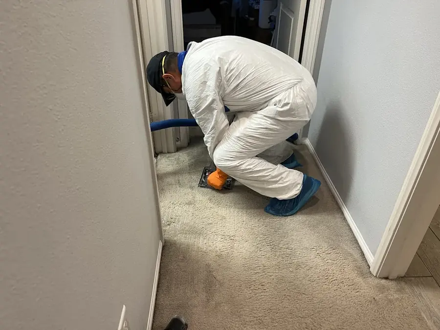 A technician checking a moisture reading in a Bronx, NY building