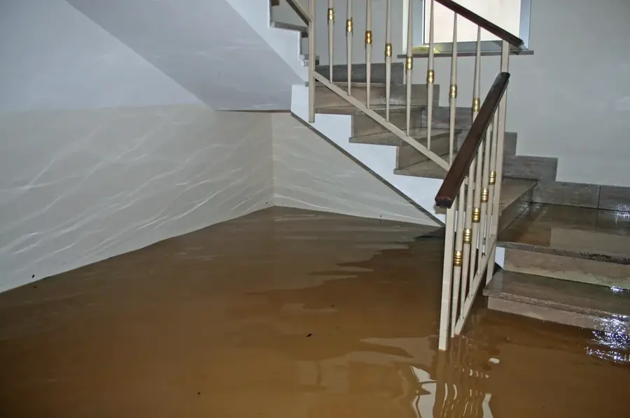 Water spreading across the floor of a Bronx, NY apartment after a leak