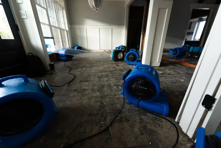 Drying equipment on a floor after an appliance supply-line leak in a Bronx, NY apartment