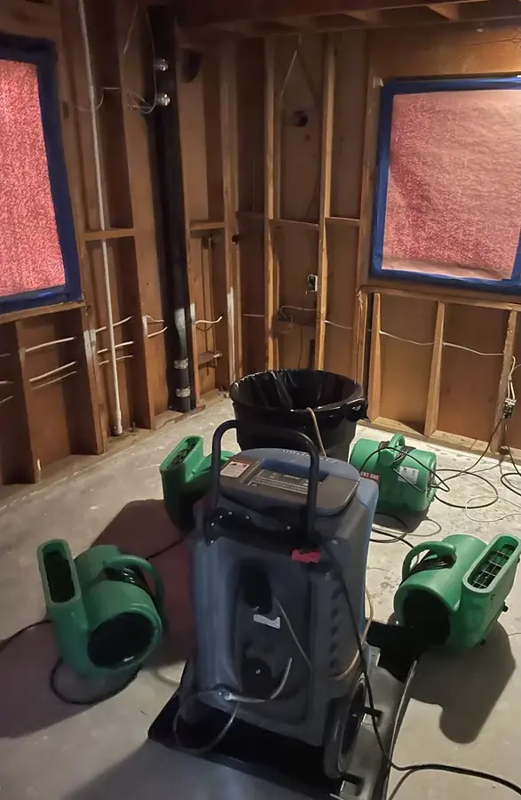 Opened wall and drying equipment after a burst pipe in a Bronx, NY building